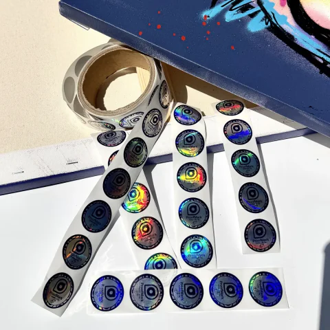 markmy.art NFC sticker roll and sticker strips beside a canvas